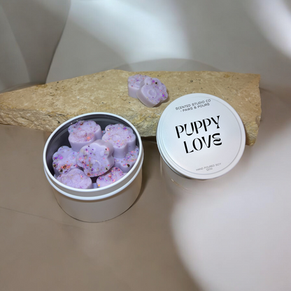 Paw-print soy wax melts packaged in elegant white tins, designed for a clean and eco-friendly aromatic experience