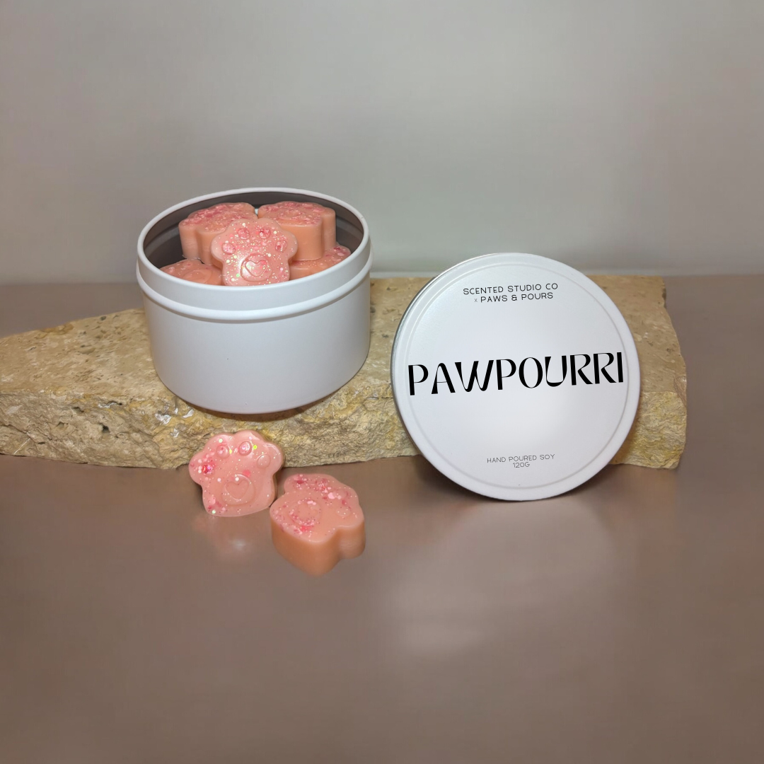 Paw-print soy wax melts packaged in elegant white tins, designed for a clean and eco-friendly aromatic experience